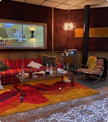 Cozy vintage living room with colorful decor.