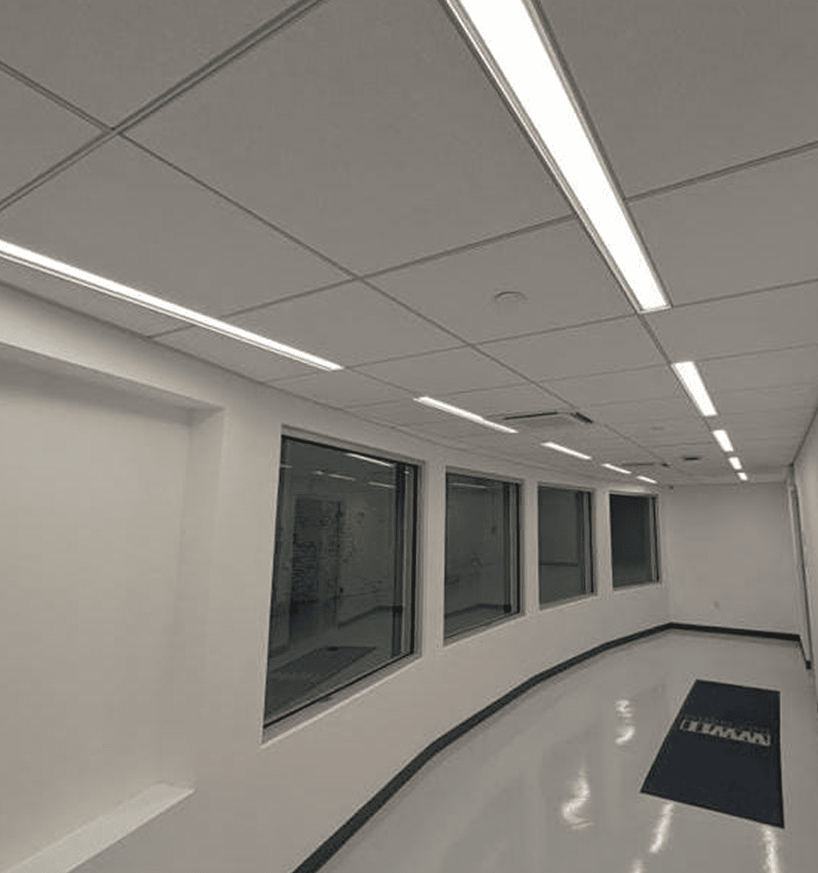 Hallway with windows and ceiling lights.